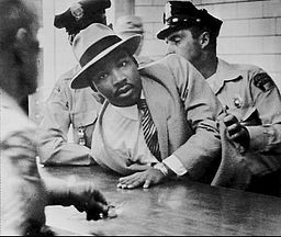 Martin Luther King Jr. being arrested in Montgomery, Alabama in 1958, the year before his speech in Hartford.